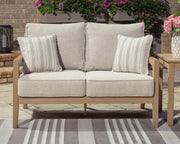 Ashley Furniture Hallow Creek outdoor loveseat with cushion, featuring a cozy seating area and stylish design.