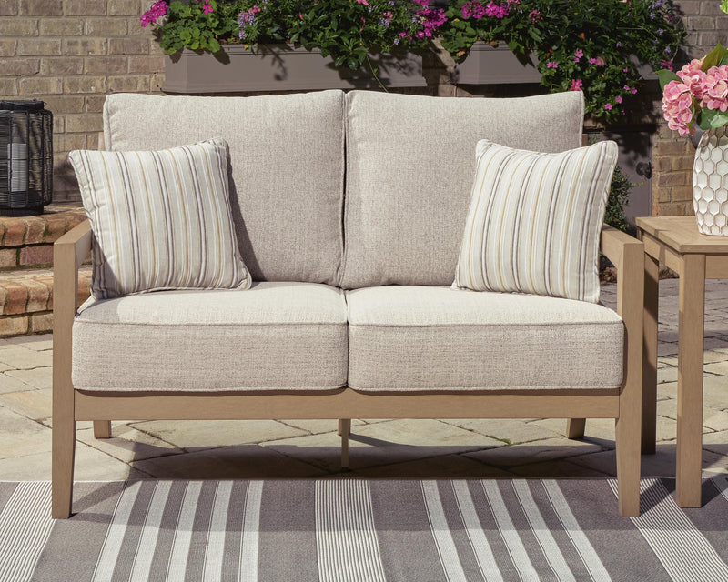 Ashley Furniture Hallow Creek outdoor loveseat with cushion, featuring a cozy seating area and stylish design.