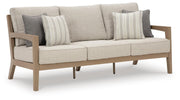 Ashley Furniture Hallow Creek outdoor sofa with cushion, featuring a stylish design ideal for patio or garden seating.