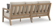 Ashley Furniture Hallow Creek outdoor sofa with cushion, featuring a stylish frame and comfortable seating for outdoor spaces.