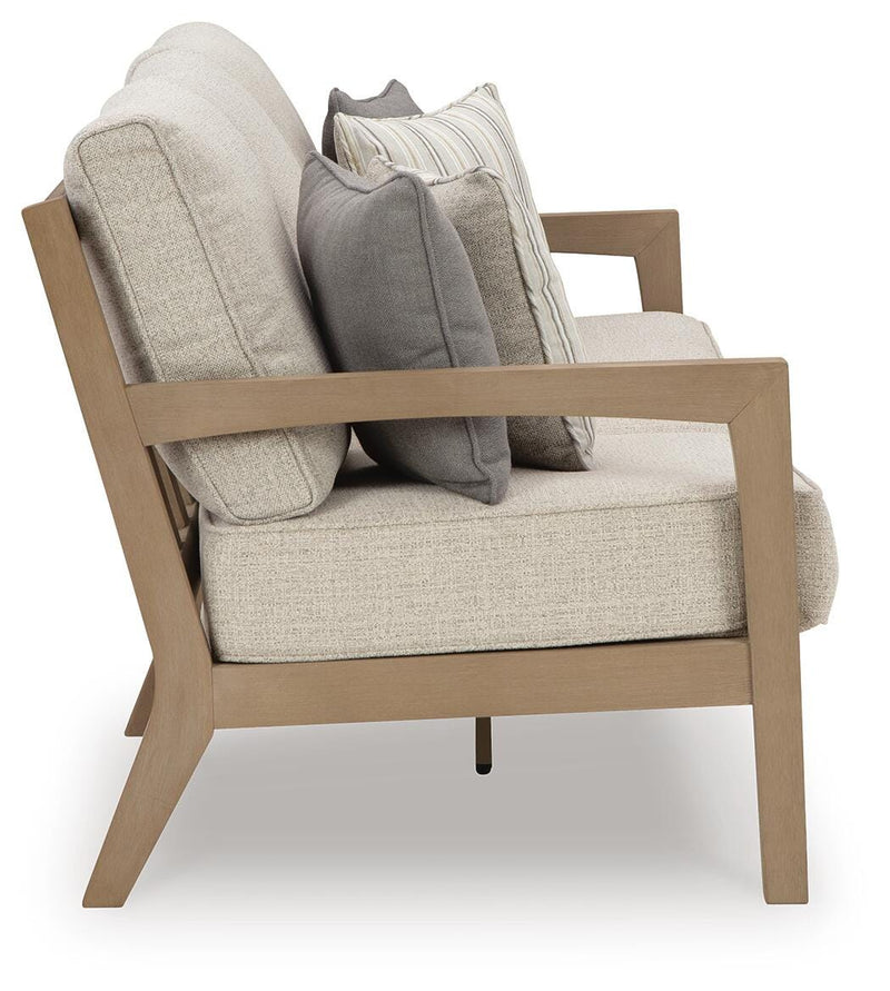 Ashley Furniture Hallow Creek outdoor sofa with cushion, featuring a stylish frame and comfortable seating for outdoor spaces.