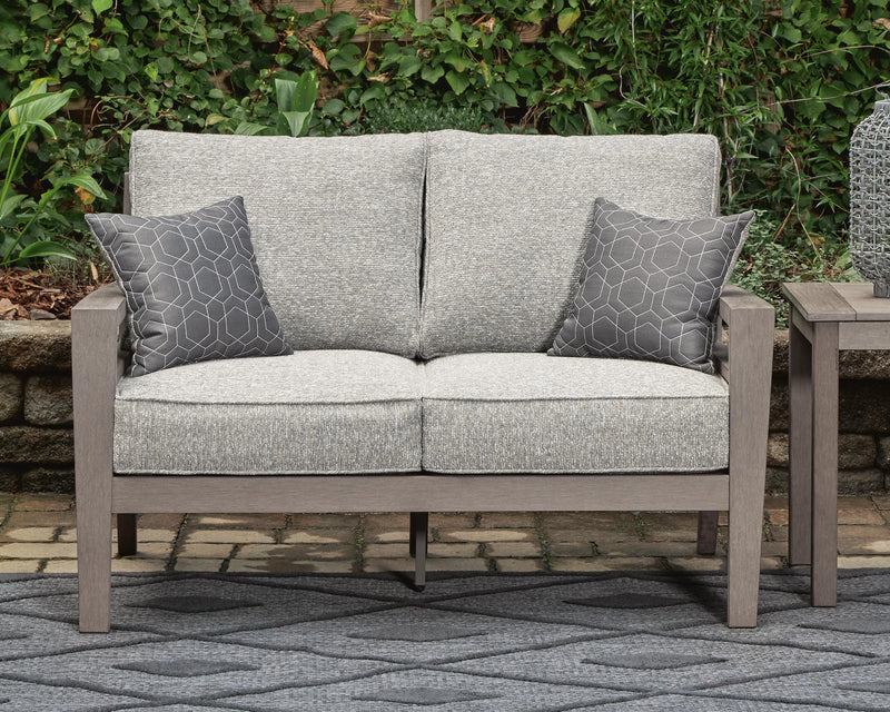 Ashley Furniture Hillside Barn outdoor loveseat with cushion, featuring a sturdy wooden frame and comfortable seating for outdoor spaces.