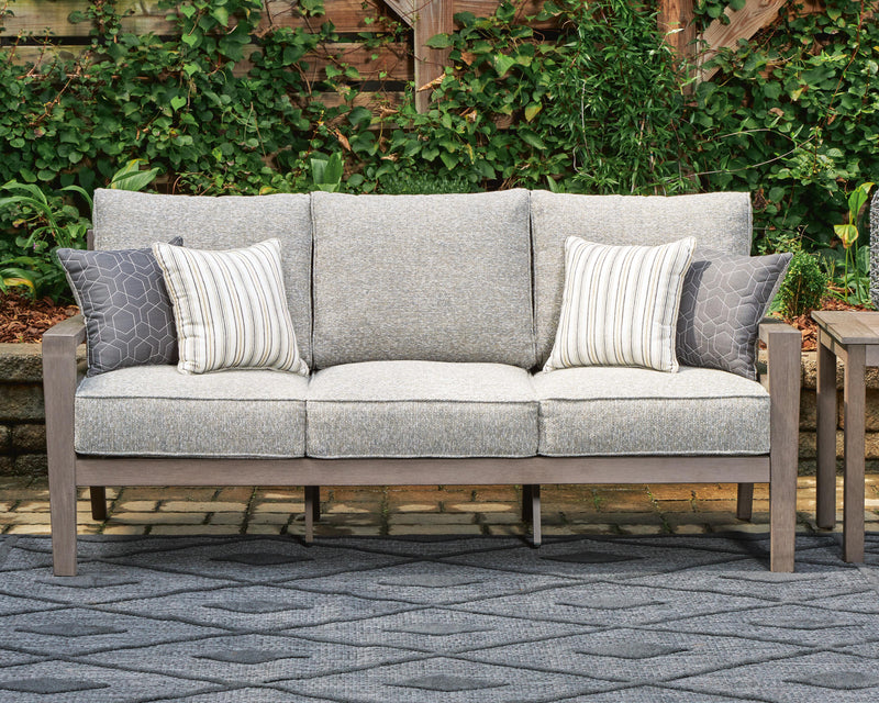 Ashley Furniture Hillside Barn outdoor sofa with cushion, featuring a rustic wooden frame and plush seating for outdoor relaxation.