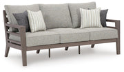 Ashley Furniture Hillside Barn outdoor sofa with matching cushion, featuring a sturdy wooden frame and comfortable seating.