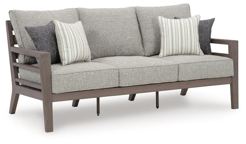 Ashley Furniture Hillside Barn outdoor sofa with matching cushion, featuring a sturdy wooden frame and comfortable seating.