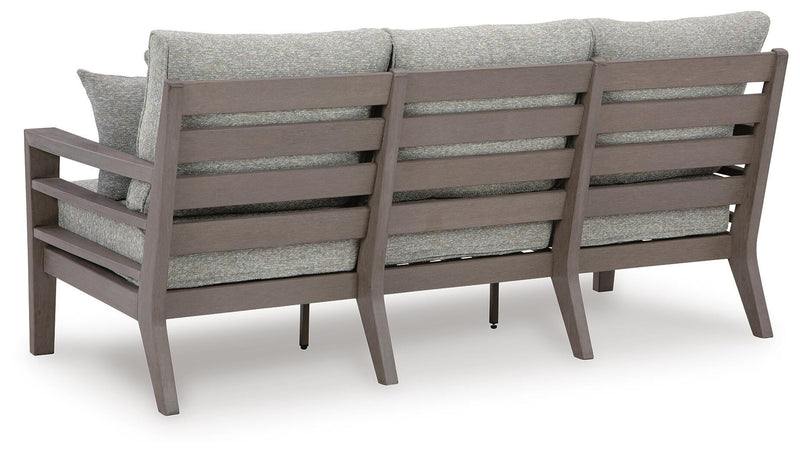 Ashley Furniture Hillside Barn outdoor sofa with cushions, showing the back view of the patio seating set.