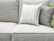 Close-up of the cushion detail on the Ashley Furniture Hillside Barn outdoor sofa, showcasing comfortable seating and stylish fabric.
