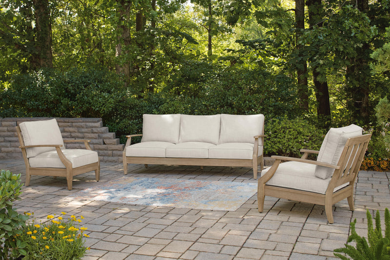 Ashley Furniture Carter Hall outdoor table set with a rectangular table and matching chairs on a patio.