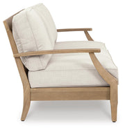 Ashley Furniture Carter Hall outdoor table set with a rectangular table and four matching chairs in a garden setting.