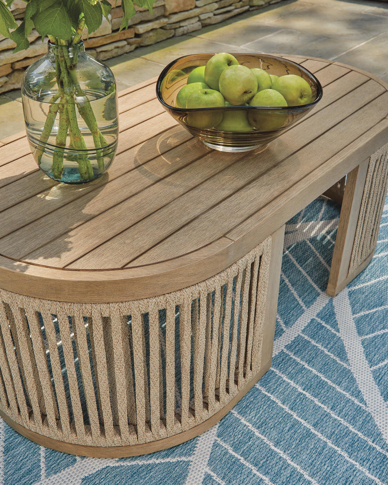 Serena Shores outdoor seating set by Ashley Furniture featuring woven chairs and a matching table for patio relaxation.
