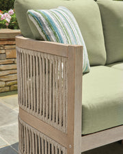 Ashley Furniture Serena Shores outdoor sofa with cushions, featuring a stylish design for outdoor living spaces.
