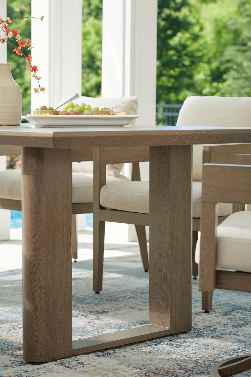 Outdoor dining table from Ashley Furniture's Serene Bay collection, featuring a sturdy base and spacious surface for outdoor meals.