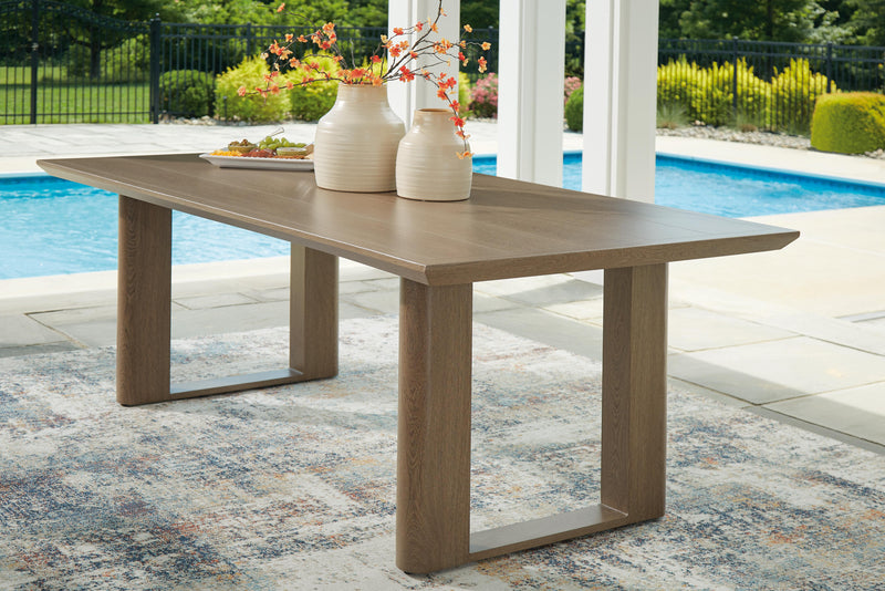 Serene Bay outdoor dining set by Ashley Furniture with a rectangular table and six matching chairs in a garden setting.