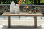 Outdoor cocktail table by Ashley Furniture with a rectangular design and slatted top, perfect for outdoor patio or garden spaces.