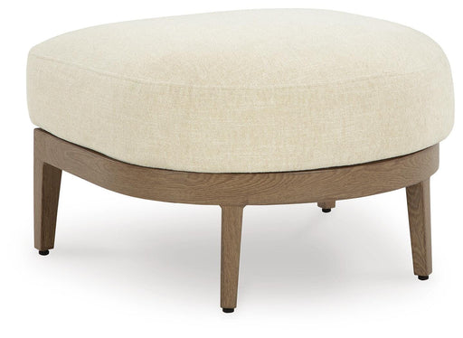 Ashley Furniture Serene Bay outdoor ottoman with cushion, shown from an angled perspective for outdoor seating and relaxation.