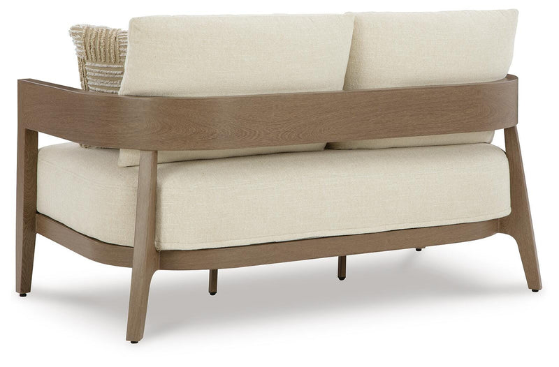 Ashley Furniture Serene Bay outdoor loveseat with cushions, featuring a stylish wooden frame and comfortable seating for outdoor spaces.