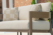 Serene Bay outdoor loveseat with cushion, Ashley Furniture outdoor seating set, featuring plush cushions and weather-resistant wicker design.