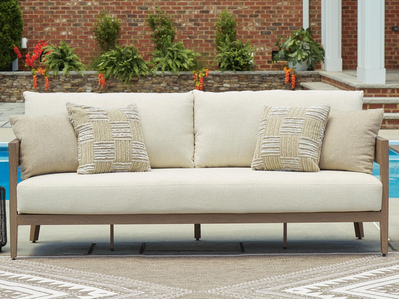Ashley Furniture Serene Bay outdoor sofa with cushions, stylish outdoor seating with plush cushions on a modern patio setting.