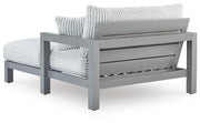 Hurley Park outdoor chaise lounge with cushion by Ashley Furniture, featuring a sleek design and comfortable seating for outdoor relaxation.