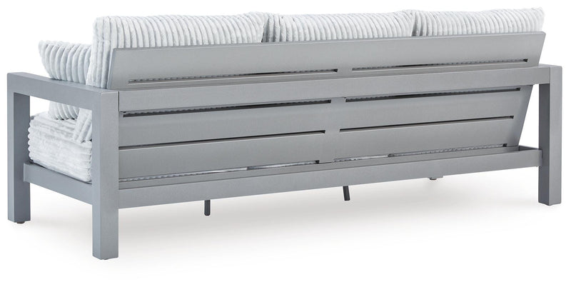 Ashley Furniture Hurley Park outdoor sofa with cushions, featuring a sturdy wooden frame and comfortable seating for outdoor spaces.