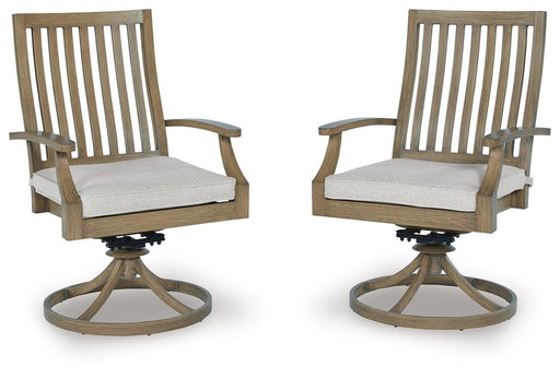Set of two Ashley Furniture Rainier Ranch outdoor swivel dining chairs with cushions, featuring woven design and sturdy frame.