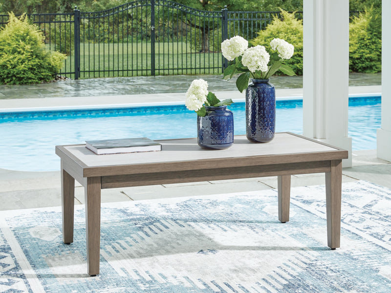 Outdoor cocktail coffee table from Ashley Furniture's Rainier Ranch collection, featuring a stylish, durable surface suitable for outdoor use.