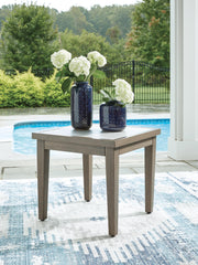 Ashley Furniture Rainier Ranch outdoor end table with a rustic wooden top and black metal frame, perfect for patio or garden decor.