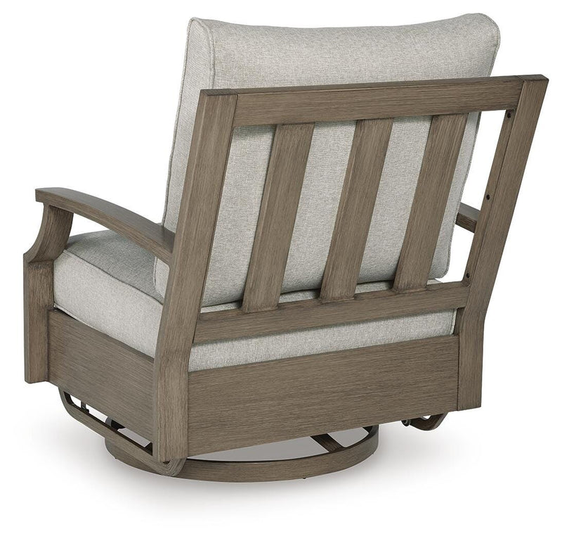 Outdoor swivel glider chair with cushion from Ashley Furniture, showing the back view of the Rainier Ranch outdoor lounge chair.