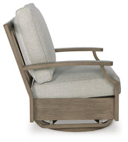 Ashley Furniture Rainier Ranch outdoor swivel glider chair with cushion, featuring a sturdy frame and comfortable seating for outdoor lounging.