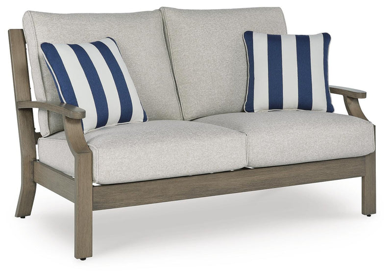 Outdoor loveseat with cushions by Ashley Furniture, featuring a sturdy frame and comfortable seating for outdoor relaxation.