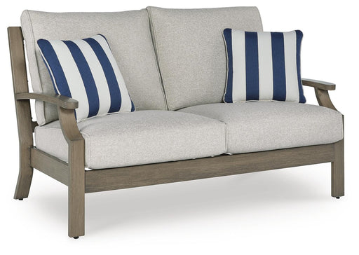 Outdoor loveseat with cushions by Ashley Furniture, featuring a sturdy frame and comfortable seating for outdoor relaxation.