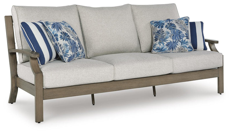 Ashley Furniture Rainier Ranch outdoor sofa with cushions, featuring a stylish design and comfortable seating for outdoor spaces.