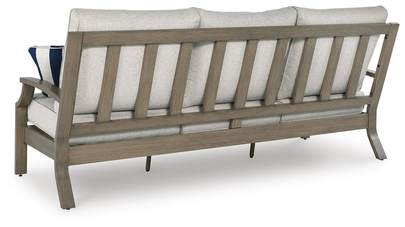 Outdoor sofa with cushions from Ashley Furniture's Rainier Ranch collection, featuring a sturdy frame and comfortable seating.