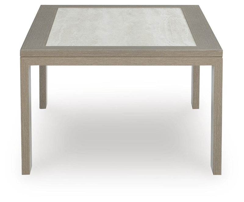 Ashley Furniture Kimpton Isle outdoor cocktail table with a woven rattan design and glass top for patio or garden use.