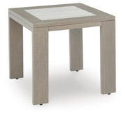 Ashley Furniture Kimpton Isle outdoor end table with a round metal frame and glass top, designed for patio and garden use.
