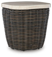 Ashley Furniture Kimora outdoor end table with a woven rattan-style design and sturdy wooden legs, perfect for patio or garden.