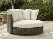 Ashley Furniture Kimora outdoor swivel lounge chair with cushion, featuring a stylish design and comfortable seating for outdoor spaces.