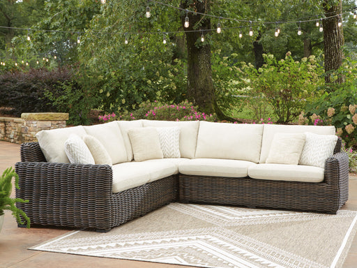 Ashley Furniture Kimora outdoor sectional with cushioned seating and weather-resistant wicker, ideal for patio lounging.