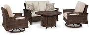 Outdoor table set with Ashley Furniture Paradise Trail loveseat, lounge chairs, and fire pit table in a cozy outdoor setting.