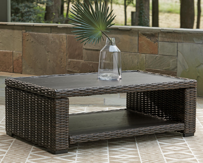 Outdoor cocktail table by Ashley Furniture with a modern design, featuring a sleek surface and sturdy legs.