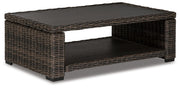 Outdoor cocktail table from Ashley Furniture's Grasson Lane collection, featuring a stylish design and sturdy construction.