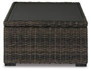 Outdoor Ashley Furniture Grasson Lane Coffee Table with a round tabletop and stylish metal frame, perfect for outdoor entertaining.