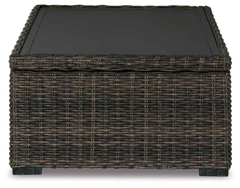 Outdoor Ashley Furniture Grasson Lane Coffee Table with a round tabletop and stylish metal frame, perfect for outdoor entertaining.
