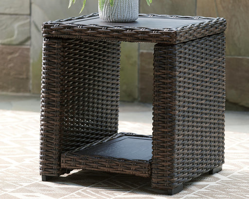 Outdoor end table by Ashley Furniture featuring a stylish Grasson Lane design with a sturdy frame and a spacious surface.