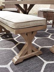 Ashley Furniture Beachcroft outdoor dining set with a glass-top table and six cushioned chairs for outdoor dining.