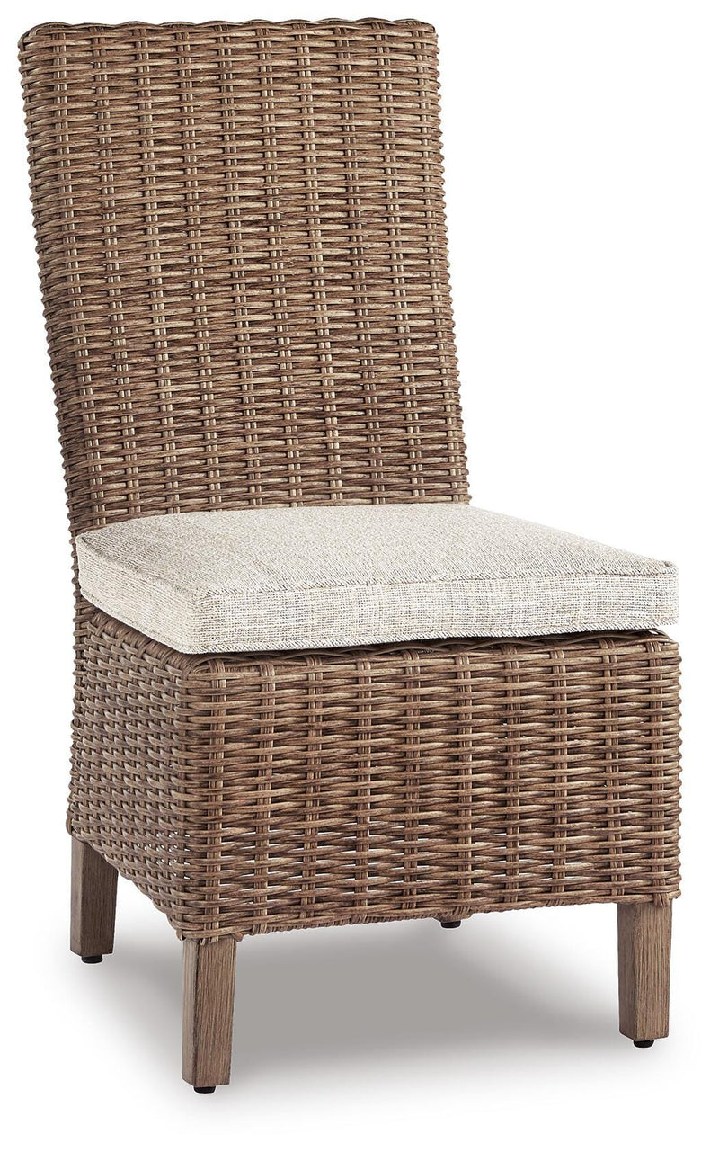 Ashley Furniture Beachcroft outdoor dining set with a table and four chairs, shown from an angled perspective on a patio.