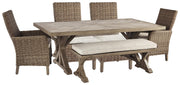 Ashley Furniture Beachcroft outdoor dining set with a table and six chairs in a patio setting, perfect for outdoor meals