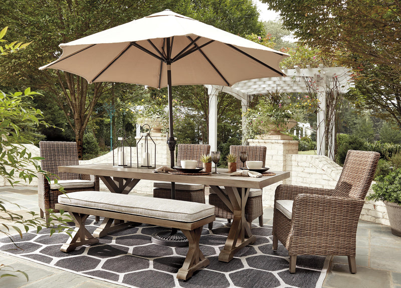 Ashley Furniture Beachcroft outdoor dining set with a round table and six matching chairs for al fresco dining.