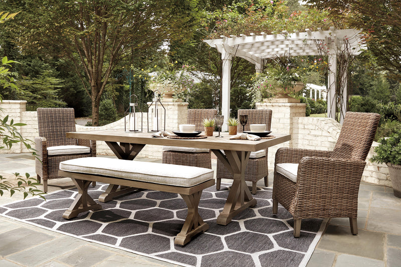 Ashley Furniture Beachcroft outdoor dining set with a round table and six matching chairs, ideal for outdoor gatherings.