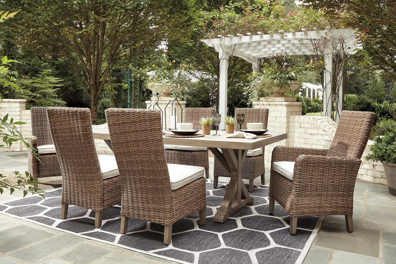 Ashley Furniture Beachcroft outdoor dining set with a rectangular table and six matching chairs on a patio.